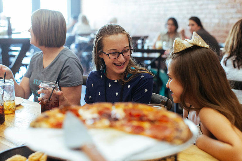 'Two girls at P-Town Pizza with drinks.