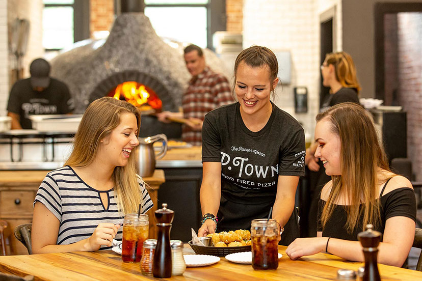 P-Town Waitress serving two customers Not Knots.